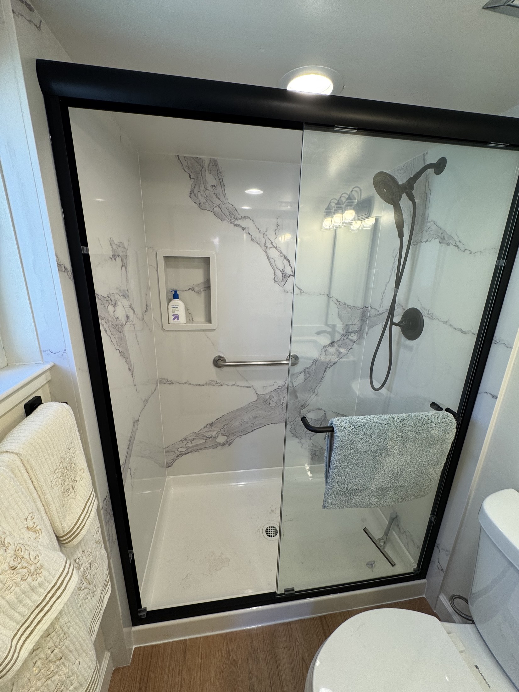 Finished marble-look shower surround by 360 Construction JN