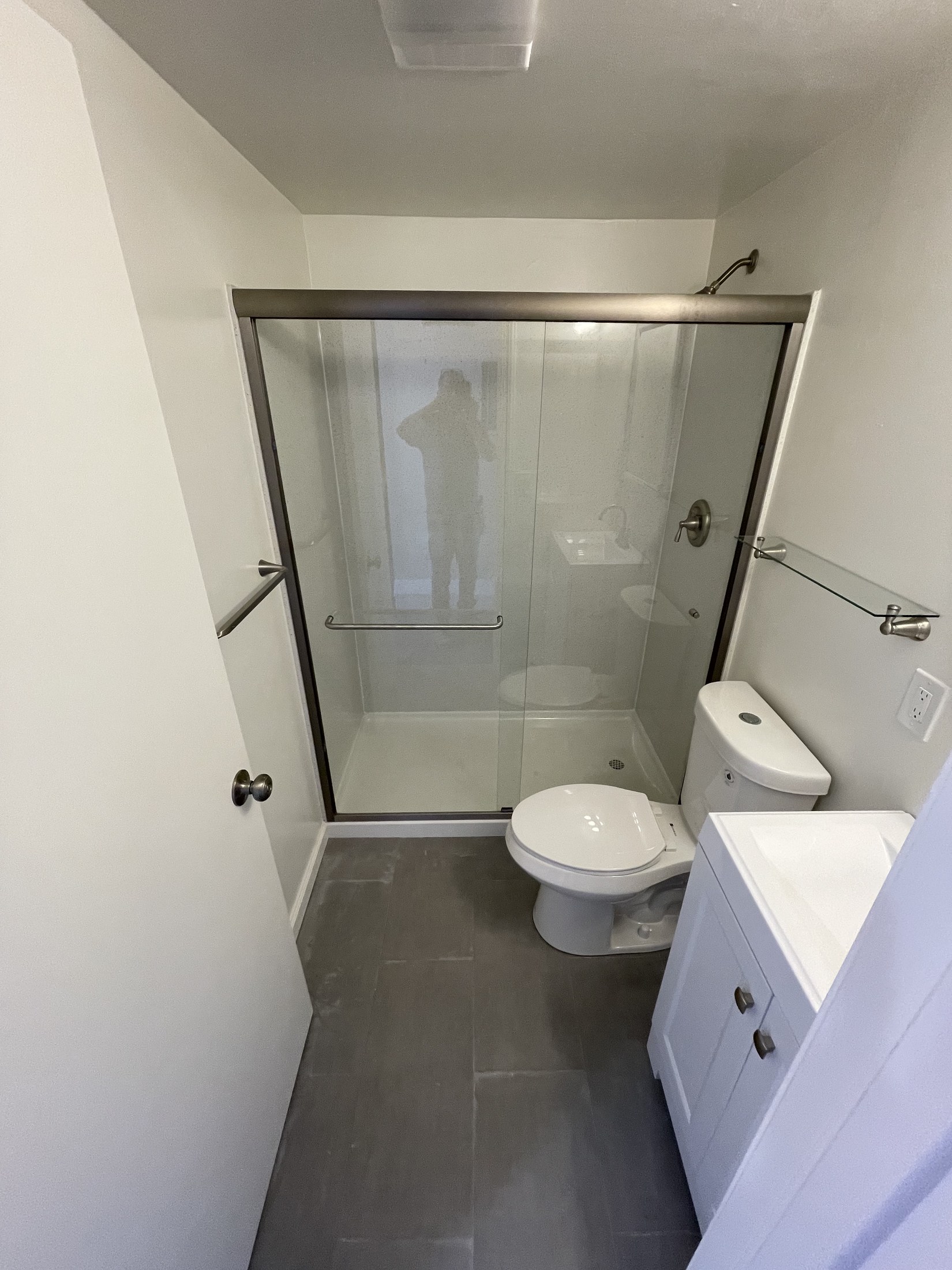 Finished bathroom with glass shower enclosure by 360 Construction JN