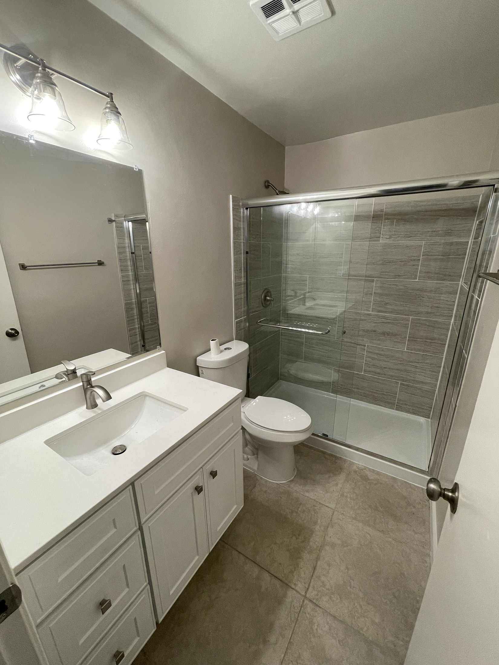 Finished bathroom vanity, tile, and shower by 360 Construction JN