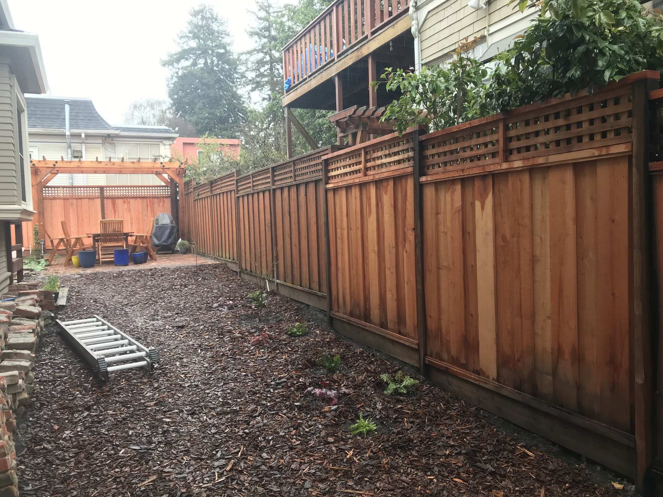 Completed fence and outdoor living area by 360 Construction JN
