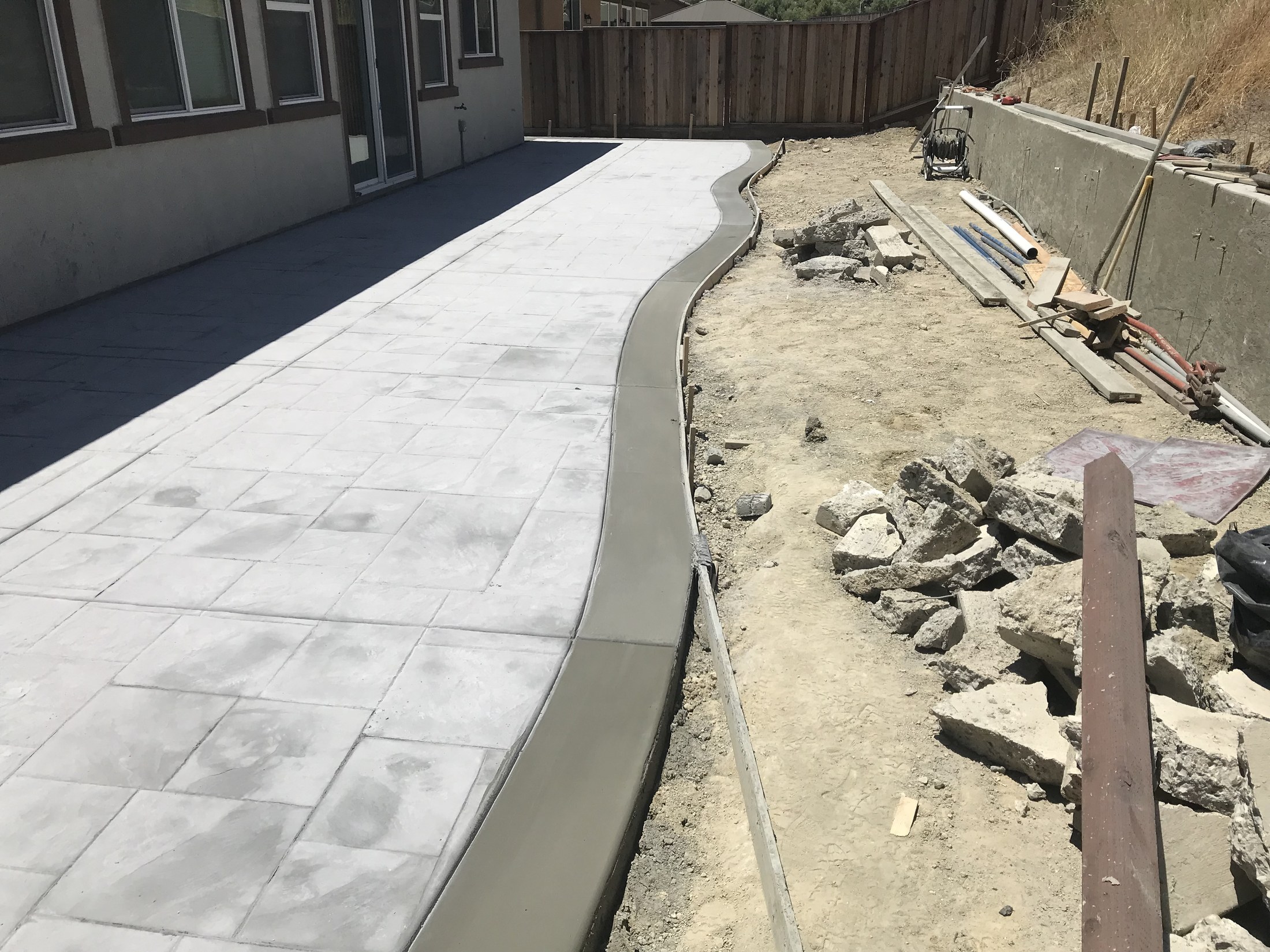 Concrete patio installation progress by 360 Construction JN